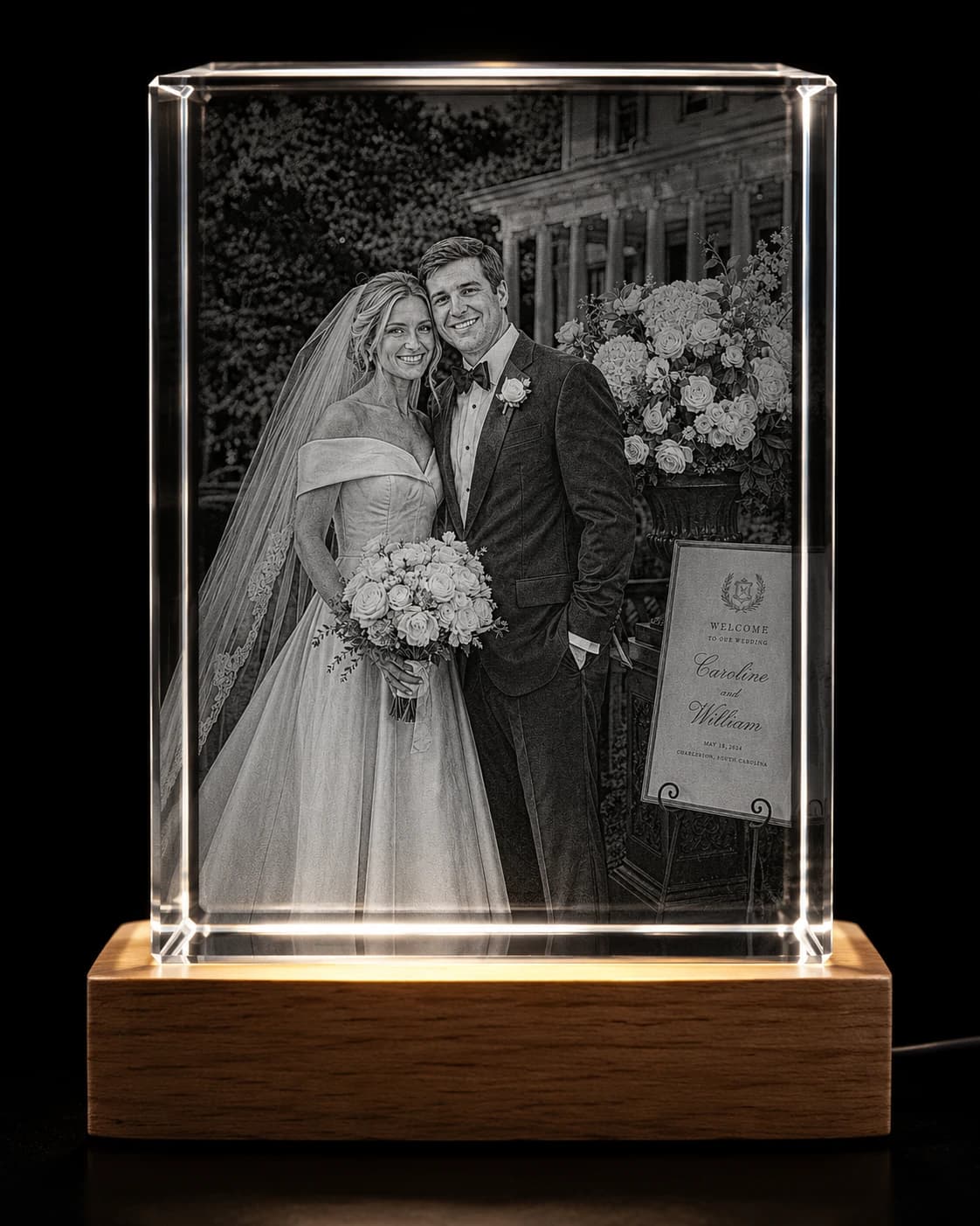Wedding portrait of a bride and groom engraved subsurface inside a rectangular crystal block on a wooden LED base